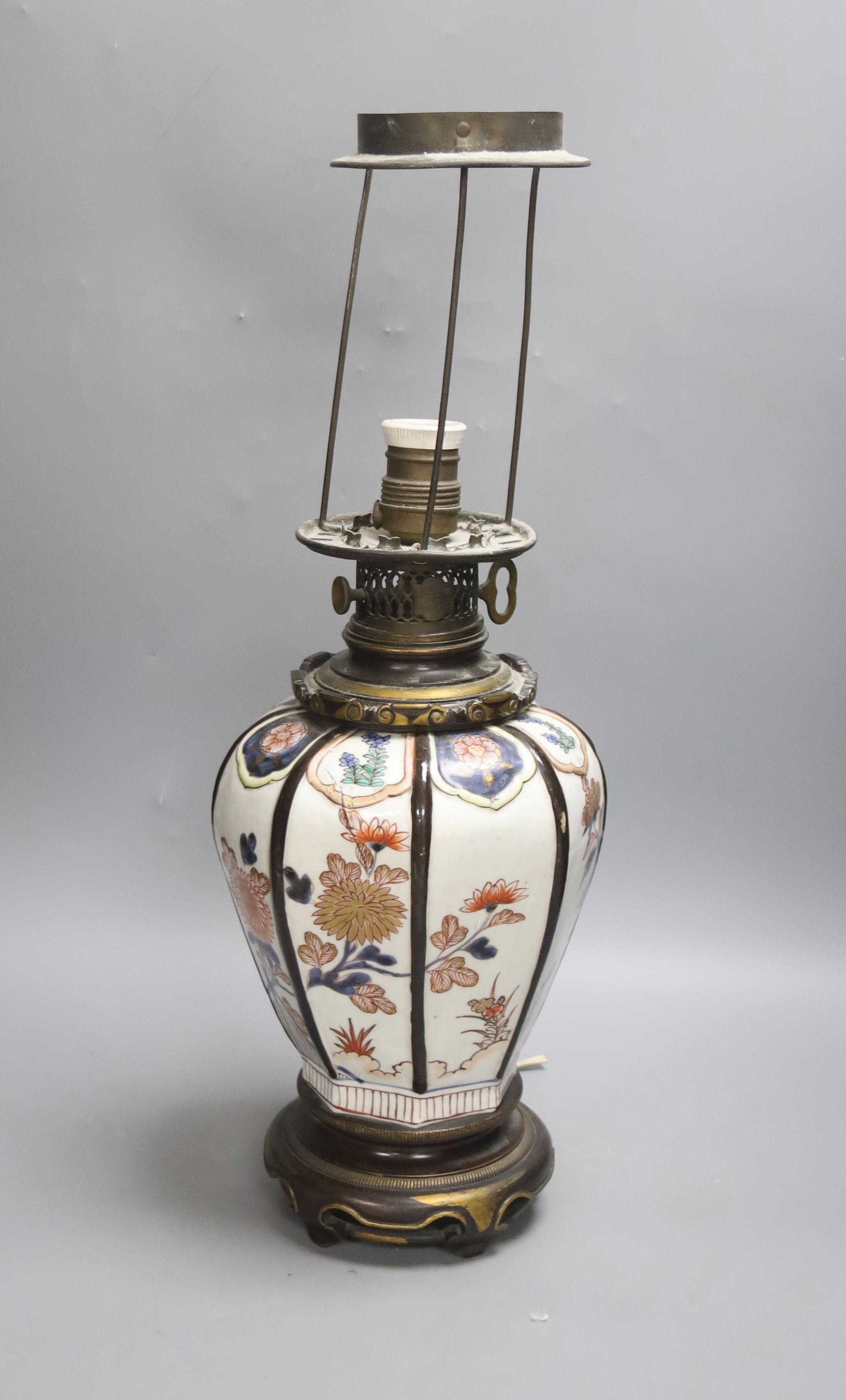 A Japanese Imari table lamp, of hexagonal form with gilt bronze fittings (formerly an oil lamp)